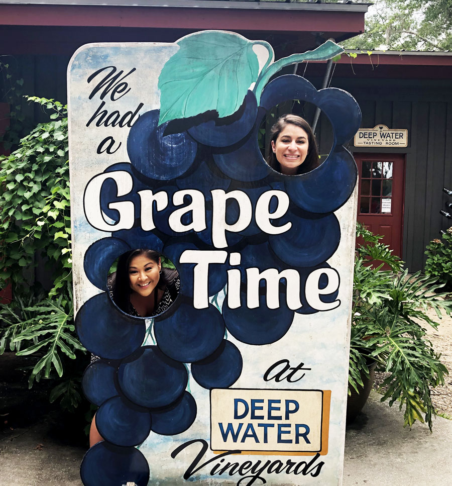 We're taking a picture in front of the Deep Water Vineyard Tasting Room