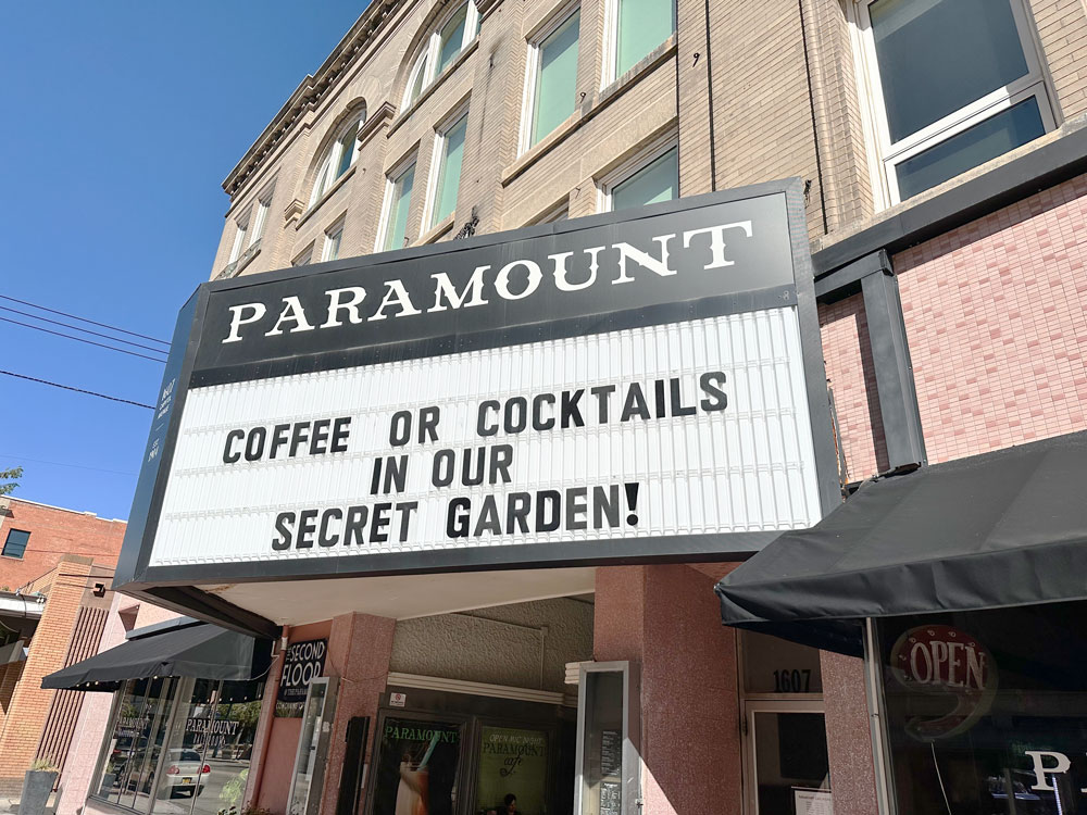 Marquee sign of the Paramount inviting guests for 'COFFEE OR COCKTAILS IN OUR SECRET GARDEN