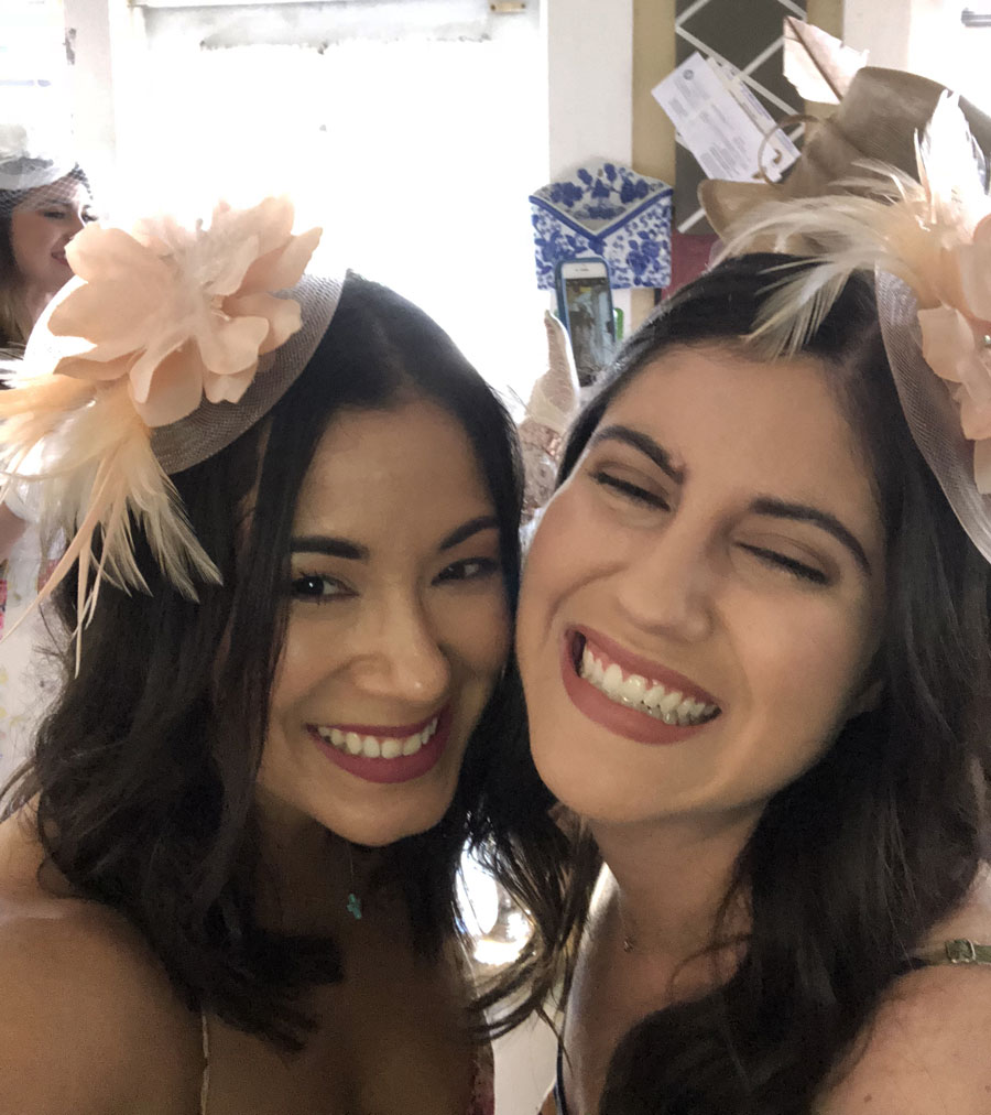 Two smiling women wearing festive headbands at a joyful gathering, capturing the spirit of West Palm Beach.