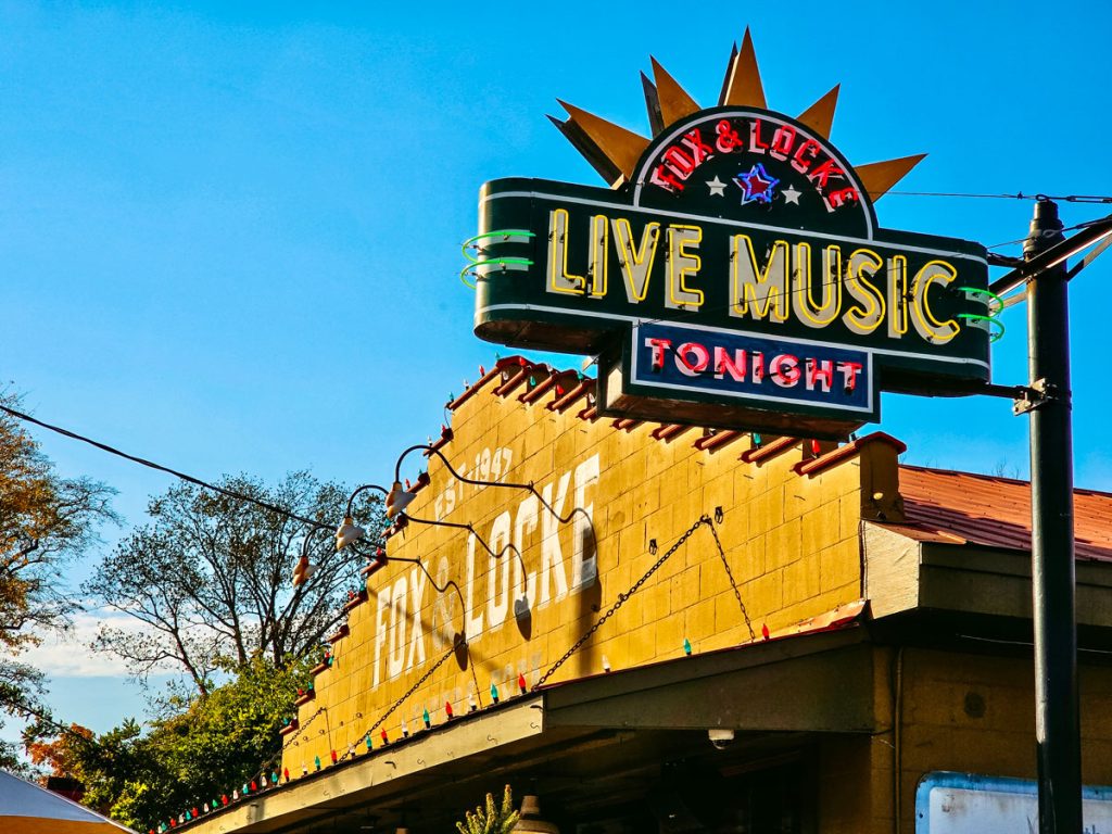 Bright neon sign reading "Fox & Locke Live Music Tonight" with a blue sky in the background, inviting visitors to enjoy live entertainment.